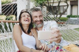 Woman and mature man taking selfie