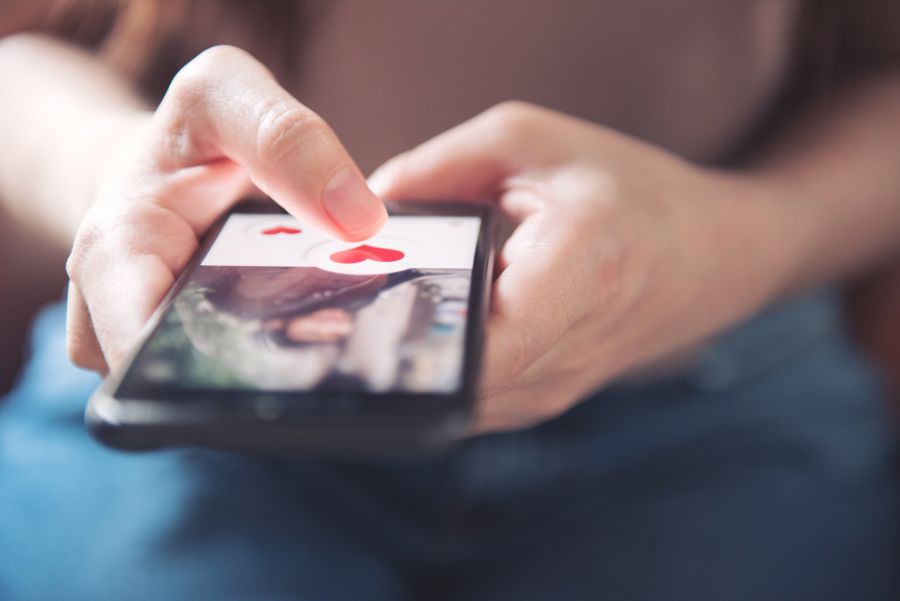 Woman using phone for online dating personals